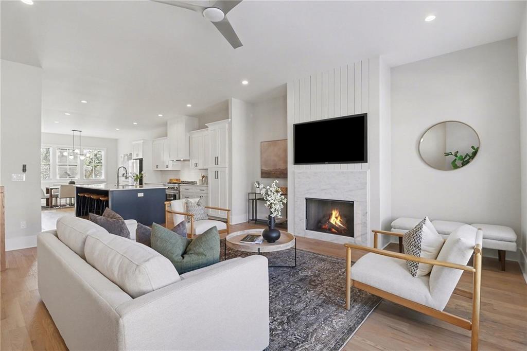 2149 Druid Flds Lane Decatur, GA 30033 - Photo 4 of 25 a living room with furniture a fireplace and a flat screen tv