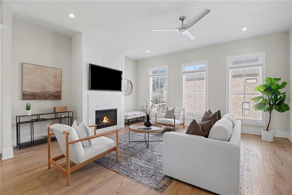 2149 Druid Flds Lane Decatur, GA 30033 - Photo 5 of 25 a living room with furniture a fireplace and a flat screen tv