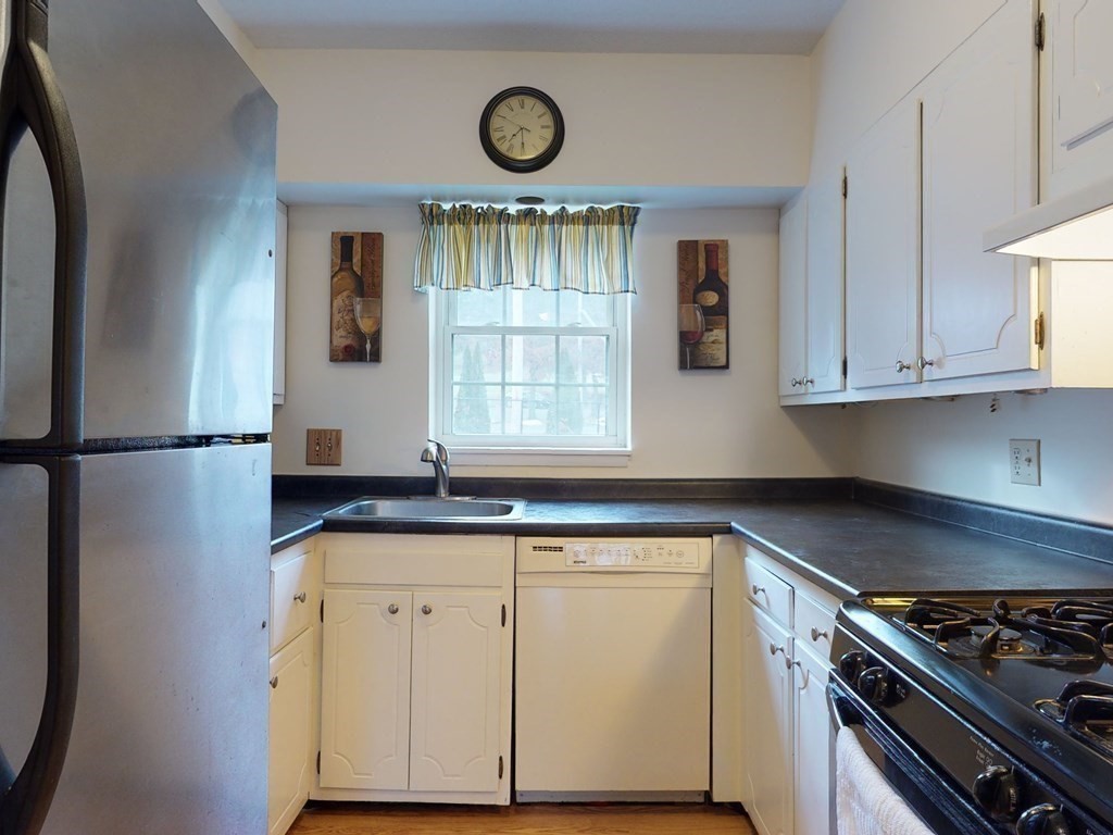 154 Lake Shore Road, Unit 2 Boston, MA 02135 - Photo 2 of 27 a kitchen with granite countertop cabinets stainless steel appliances and a window