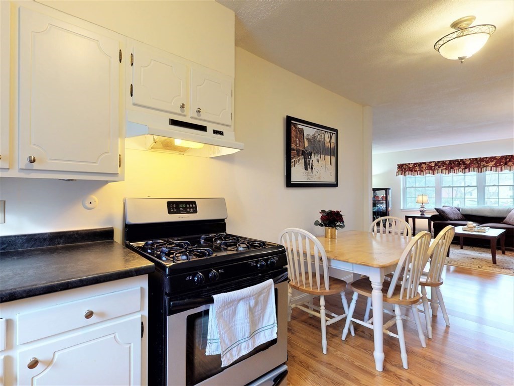 154 Lake Shore Road, Unit 2 Boston, MA 02135 - Photo 5 of 27 a kitchen with stainless steel appliances granite countertop a stove a sink and a microwave