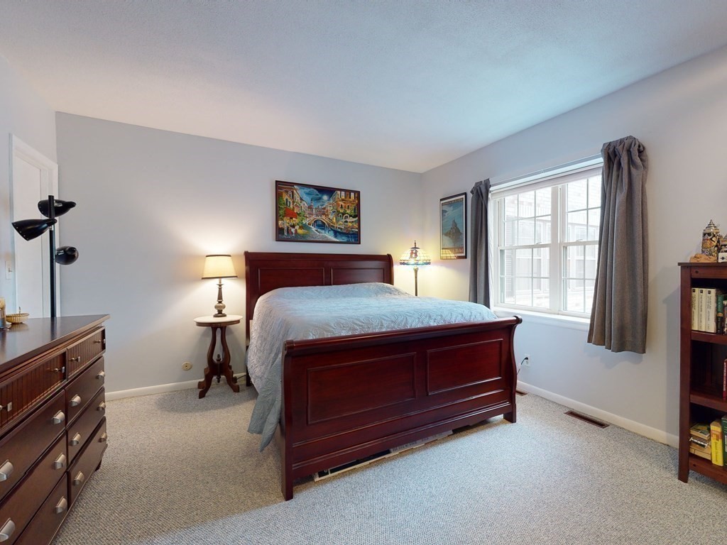 154 Lake Shore Road, Unit 2 Boston, MA 02135 - Photo 9 of 27 a bedroom with a bed dresser and a window