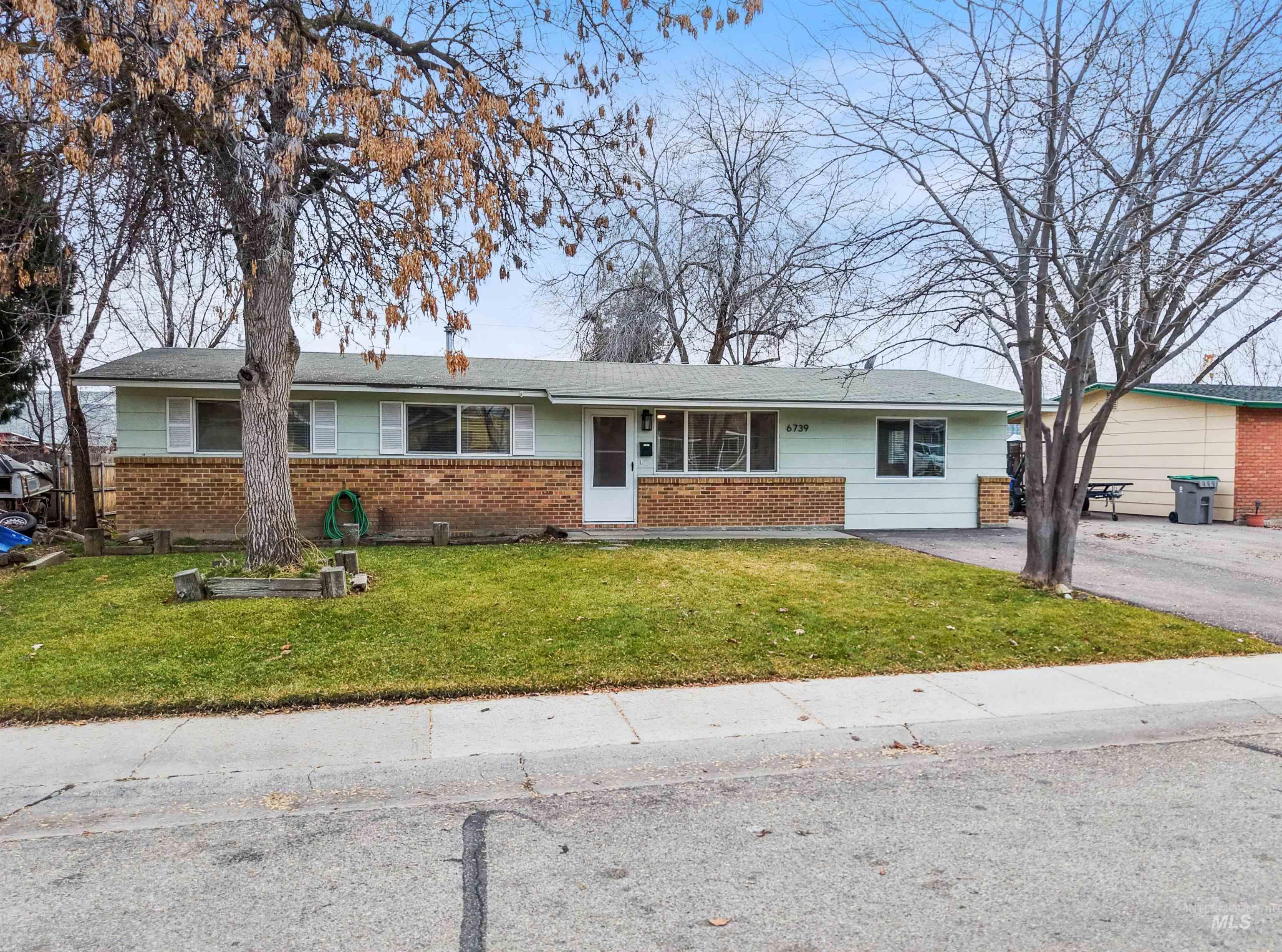 6739 West Grunder Street Boise, ID 83709 - Photo 1 of 24 Ranch-style house featuring a front yard and brick siding