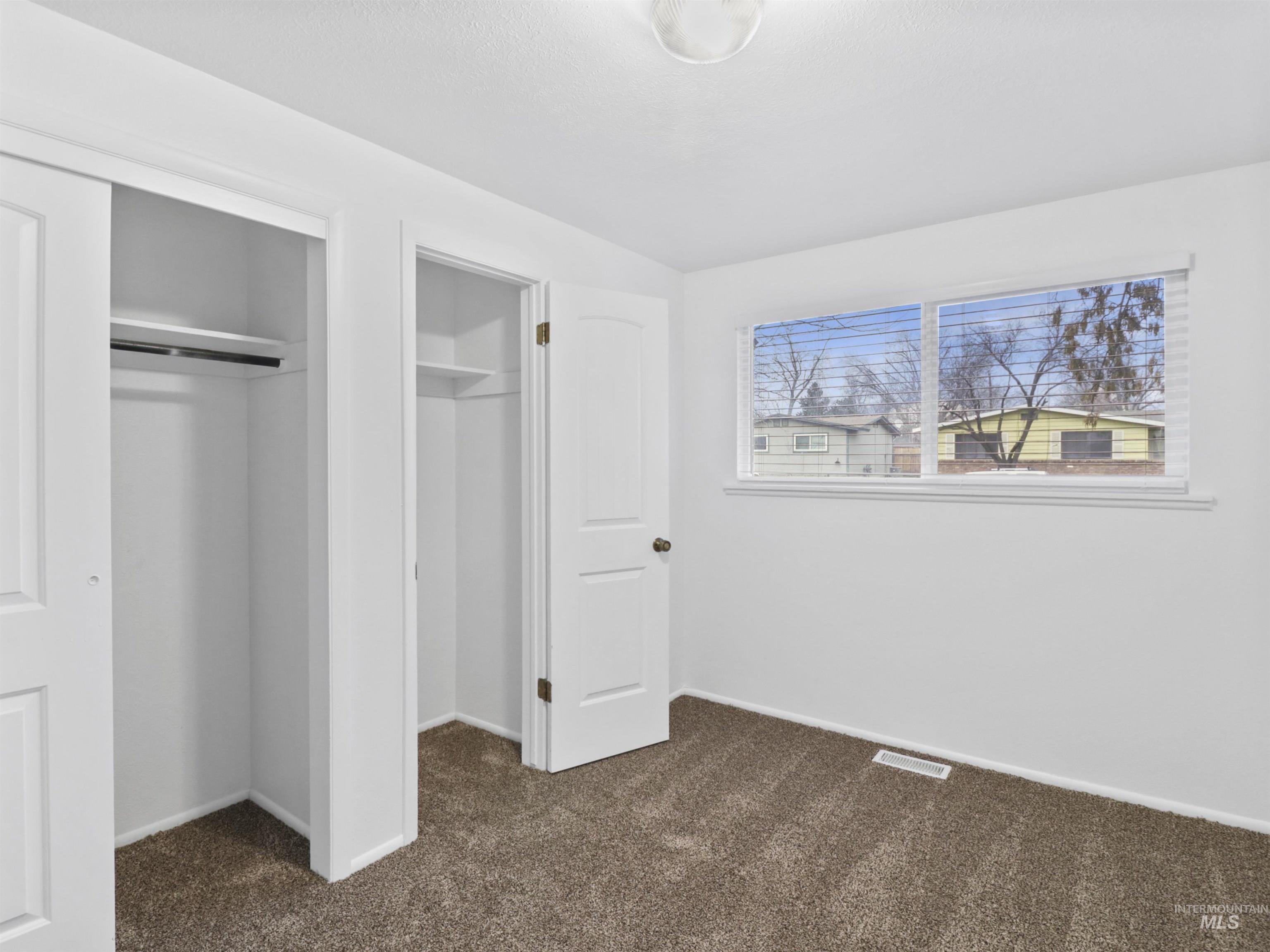 6739 West Grunder Street Boise, ID 83709 - Photo 14 of 24 Unfurnished bedroom with dark carpet and baseboards