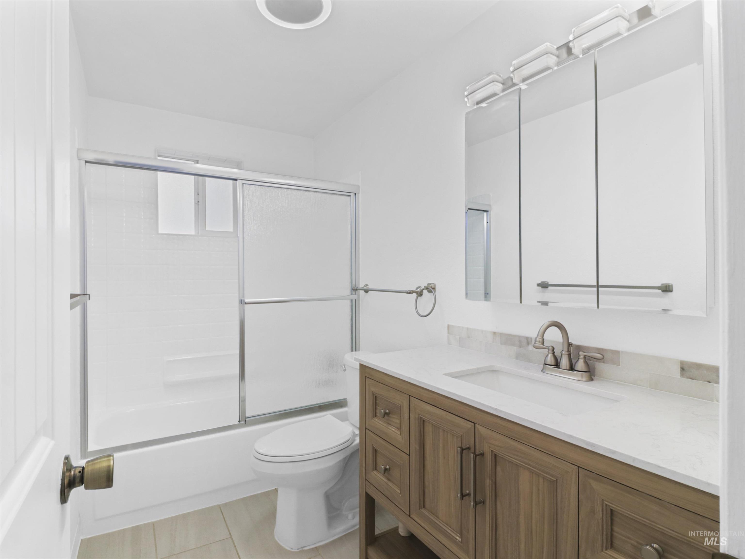 6739 West Grunder Street Boise, ID 83709 - Photo 19 of 24 Bathroom with vanity and bath / shower combo with glass door