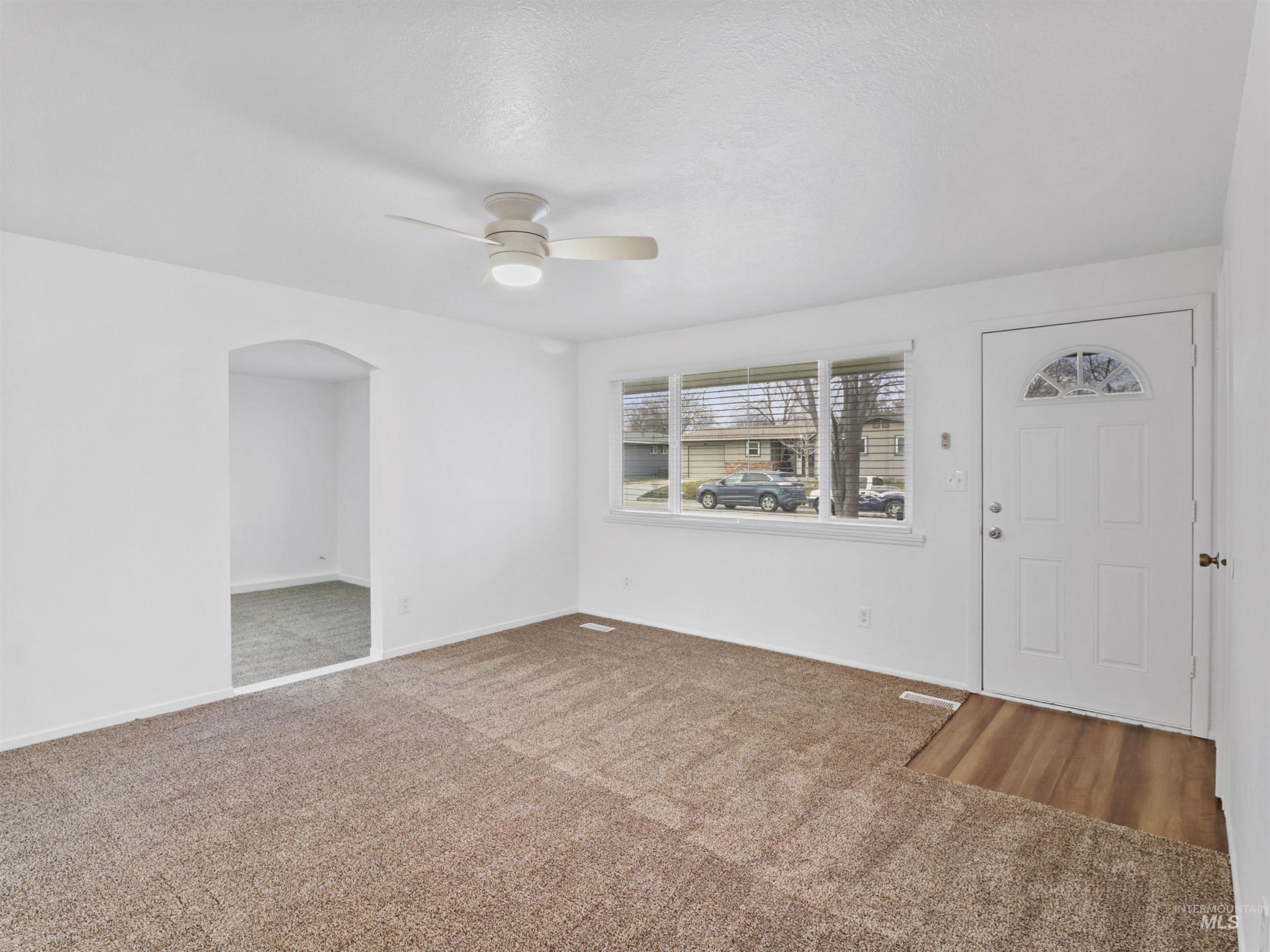 6739 West Grunder Street Boise, ID 83709 - Photo 3 of 24 Foyer featuring carpet floors, a ceiling fan, and arched walkways