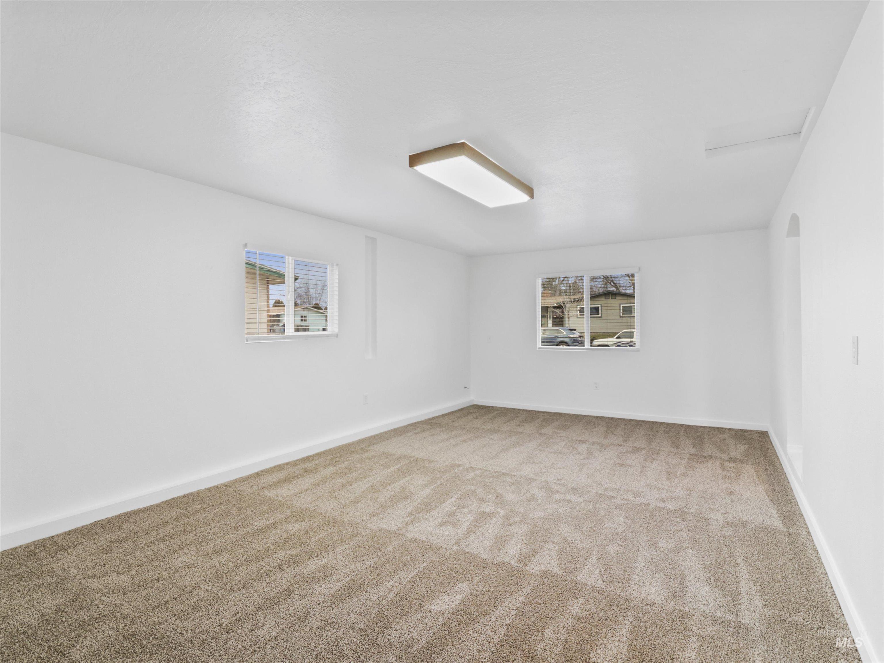 6739 West Grunder Street Boise, ID 83709 - Photo 8 of 24 Unfurnished room featuring carpet and arched walkways