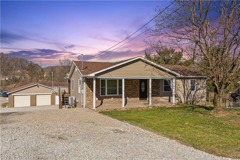 629 Upper Middletown Road Smock, PA 15480 - Photo 42 of 46 a front view of a house with a yard