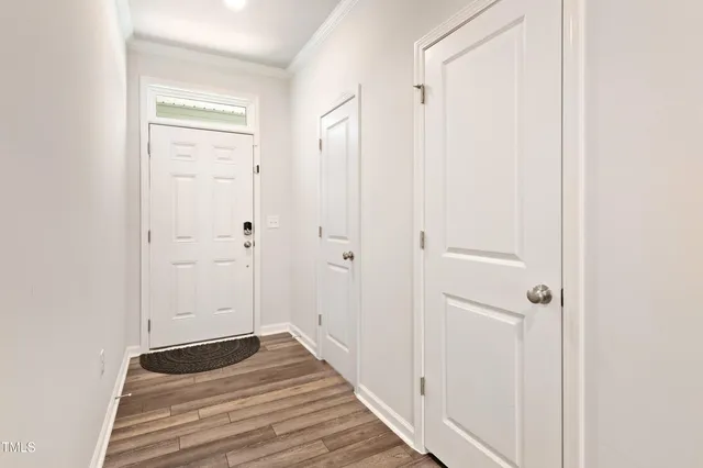 a view of a hallway with wooden floor