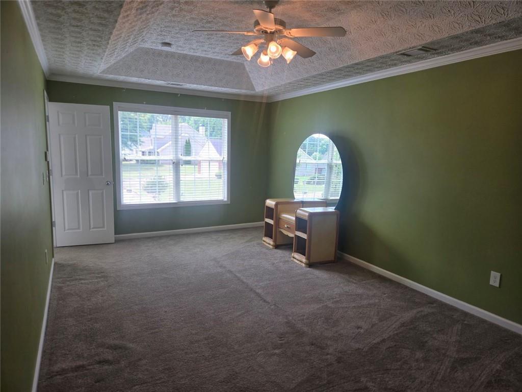 22 Windcrest Keep Covington, GA 30016 - Photo 19 of 32 a view of a livingroom with a fireplace a chandelier and windows