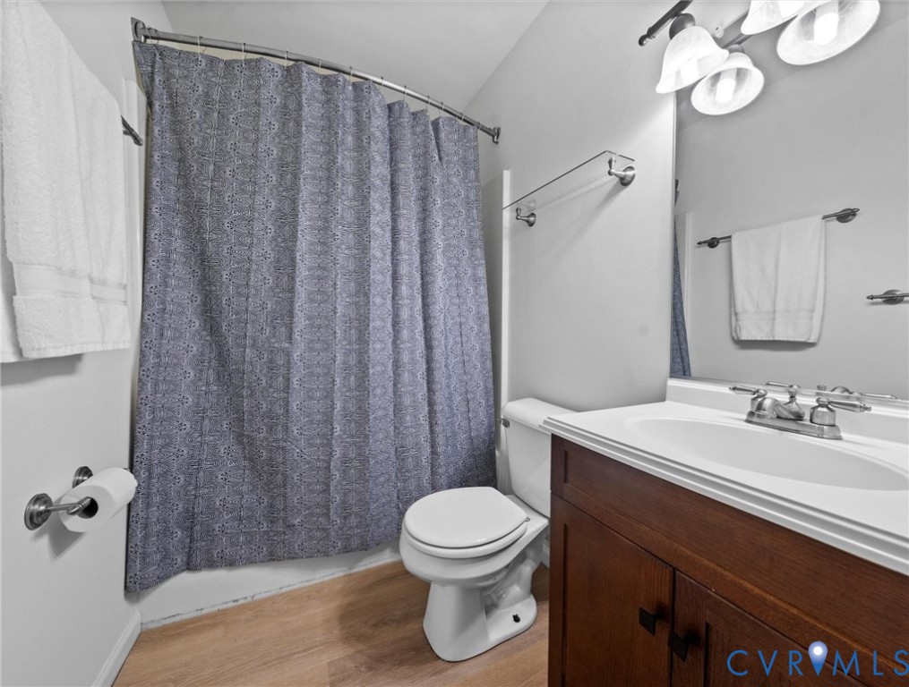 7416 Willow Ridge Terrace Glen Allen, VA 23060 - Photo 36 of 48 a bathroom with a sink a toilet a mirror and shower curtain