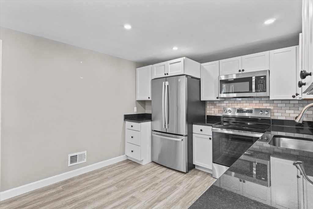 25 Purchase Street Danvers, MA 01923 - Photo 13 of 42 a kitchen with stainless steel appliances a refrigerator stove microwave and sink