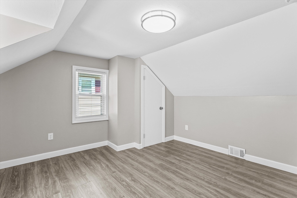 25 Purchase Street Danvers, MA 01923 - Photo 19 of 42 an empty room with wooden floor and windows