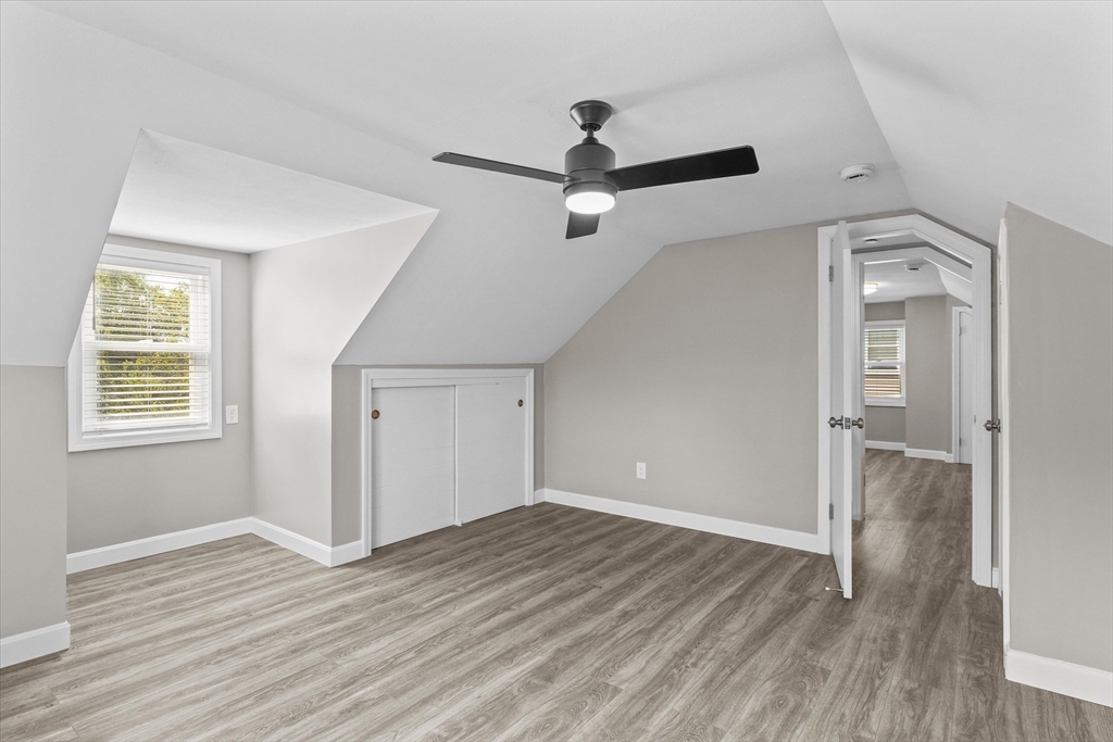 25 Purchase Street Danvers, MA 01923 - Photo 23 of 42 an empty room with wooden floor a ceiling fan and windows