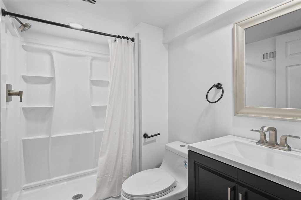 25 Purchase Street Danvers, MA 01923 - Photo 27 of 42 a bathroom with a sink a toilet and shower