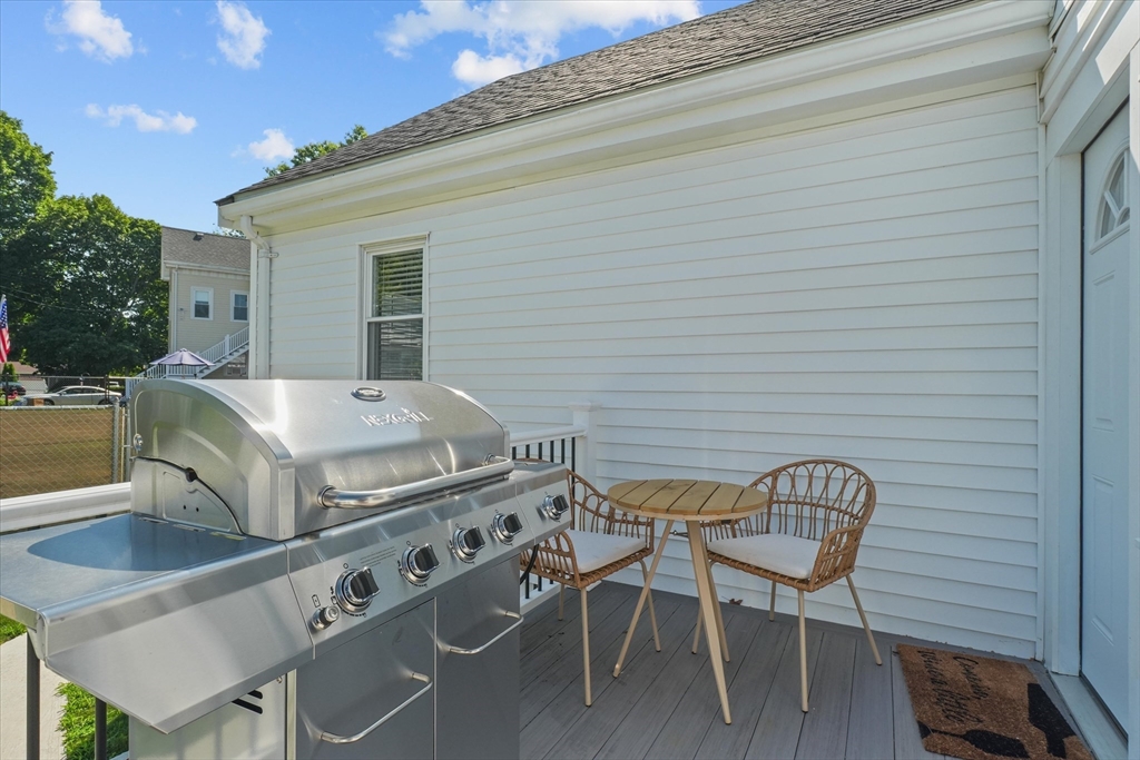 25 Purchase Street Danvers, MA 01923 - Photo 29 of 42 a view of a patio with table and chairs with wooden floor and fence