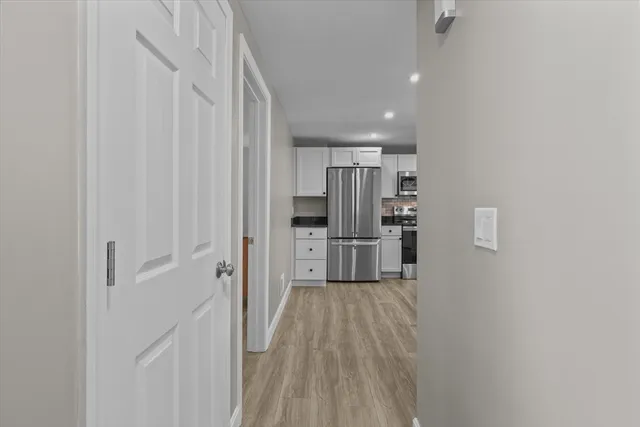 a kitchen with stainless steel appliances a refrigerator and a cabinets