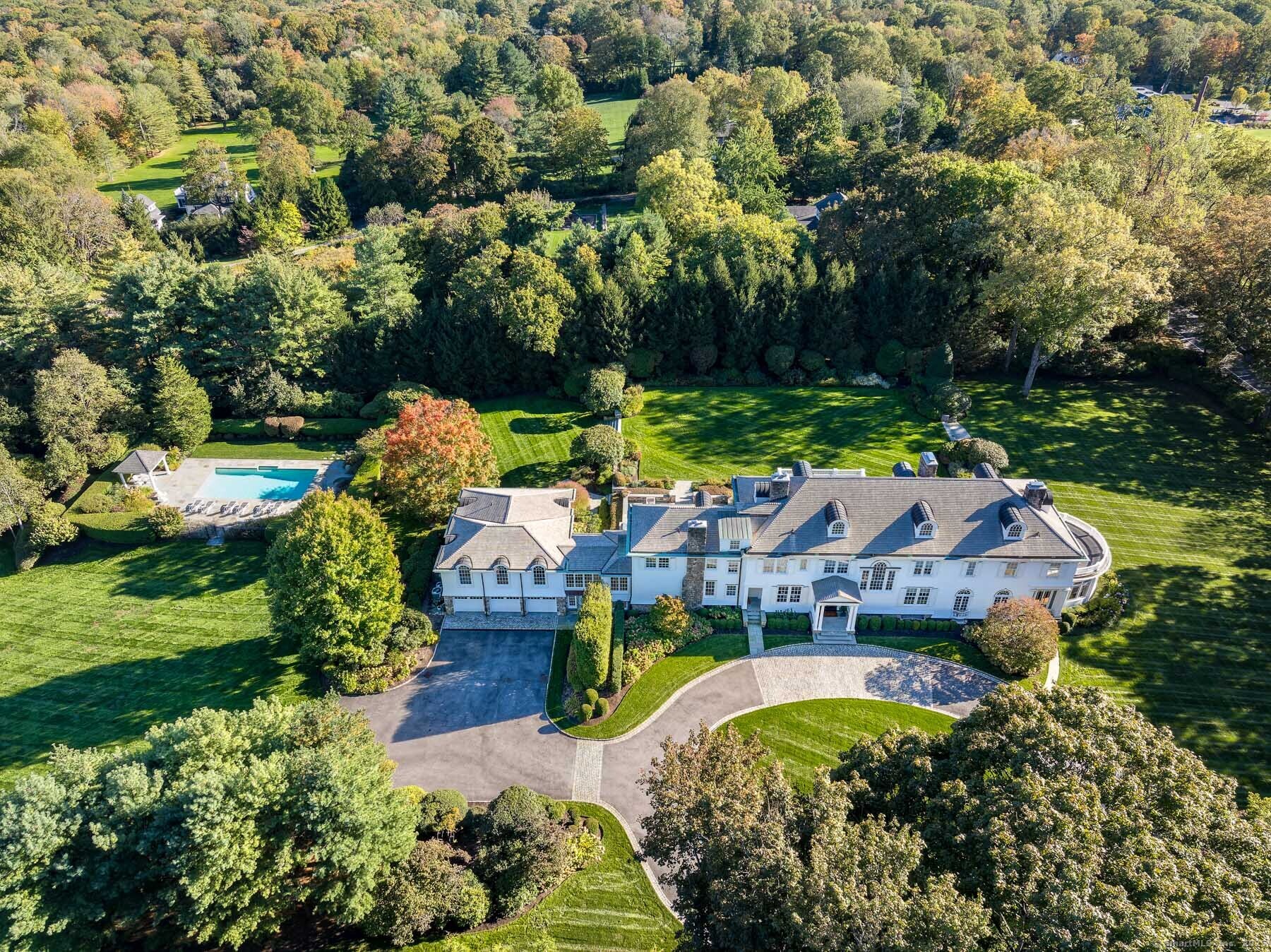 an aerial view of residential house with outdoor space and swimming pool