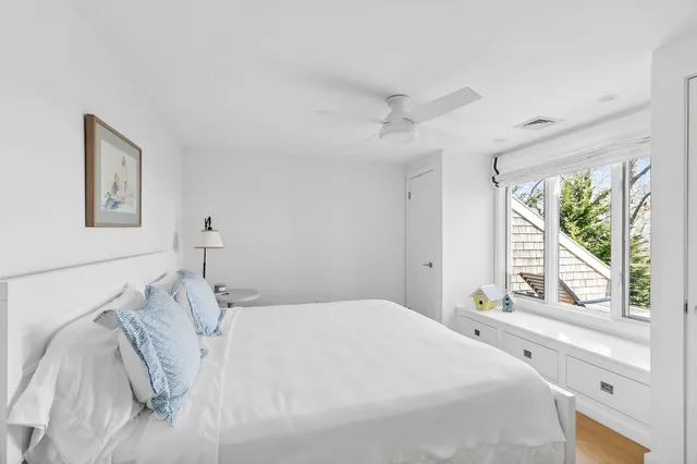 a bedroom with a large bed and a large window