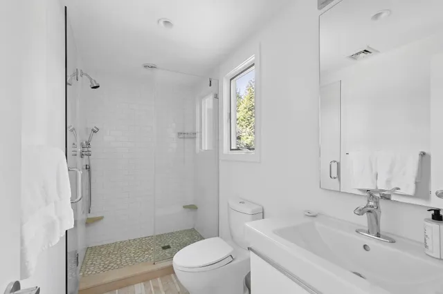 a bathroom with a sink toilet and shower