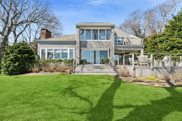 a front view of a house with a yard table and chairs