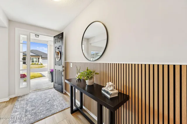 a dining room with furniture a rug and a chandelier