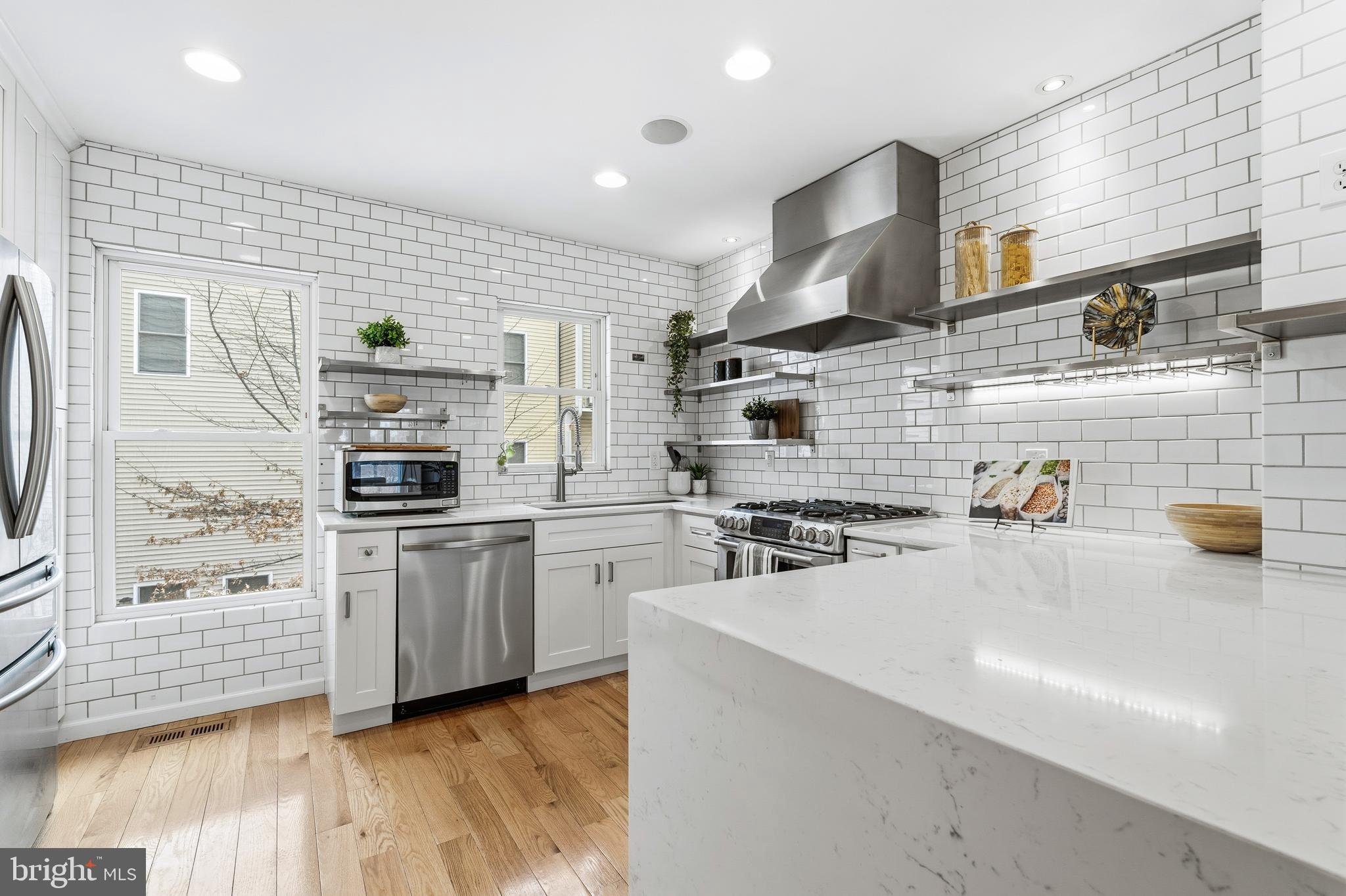 353 L Street Southeast Washington, DC 20003 - Photo 10 of 36 a kitchen with stainless steel appliances a sink a stove and a refrigerator