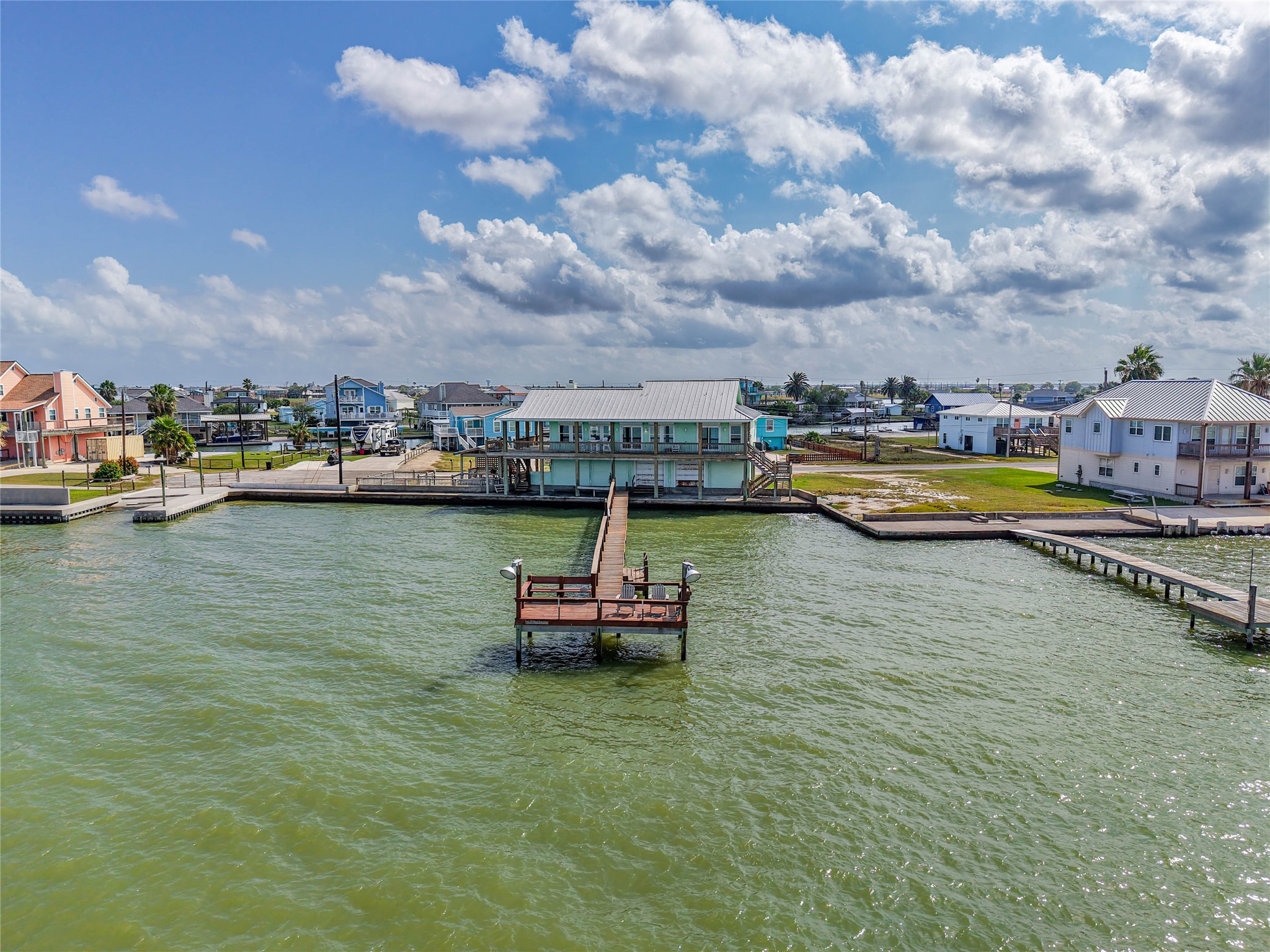 740 Copano Cove Road Rockport, TX 78382 - Photo 2 of 35 a view of a lake with boats and trees in the background