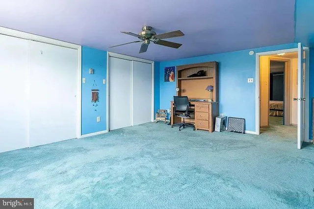 a view of a livingroom with a ceiling fan and a rug