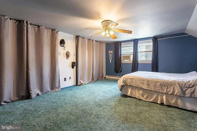 a spacious bedroom with a large bed and a chandelier