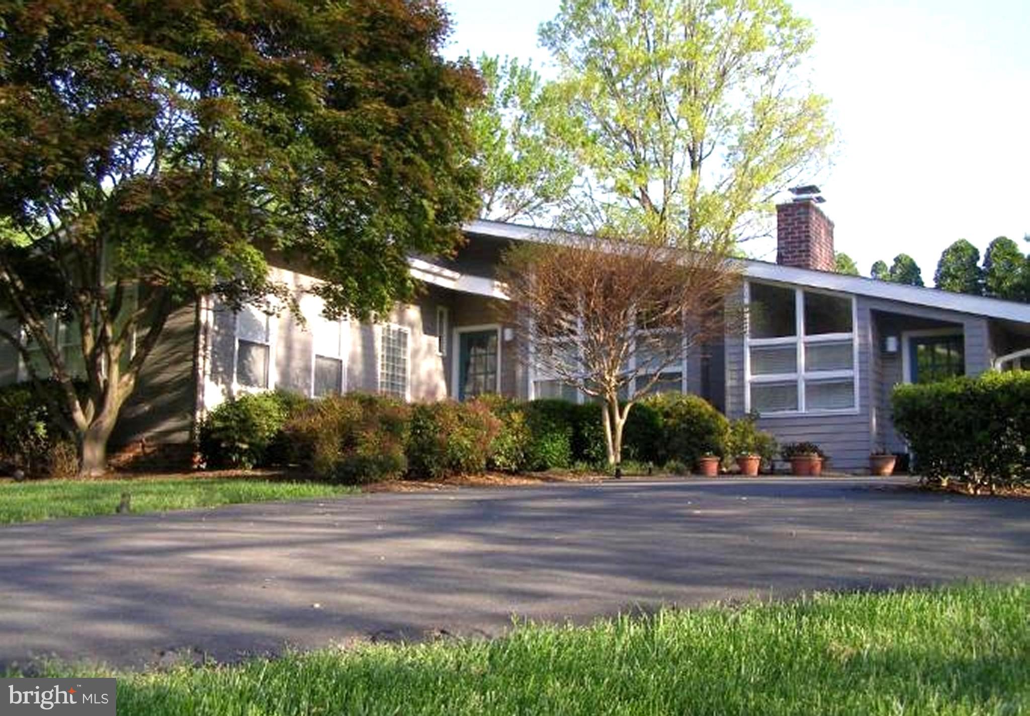 11001 Brent Road Potomac, MD 20854 - Photo 1 of 23 a front view of a house with a yard