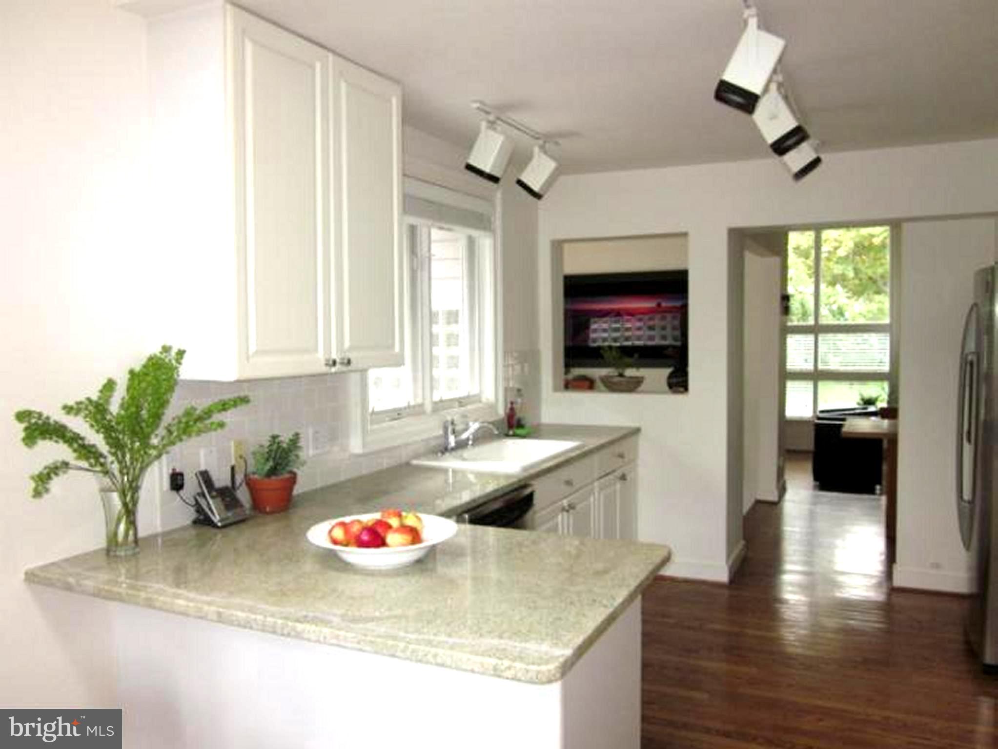 11001 Brent Road Potomac, MD 20854 - Photo 19 of 23 a kitchen with a stove a faucet and cabinets