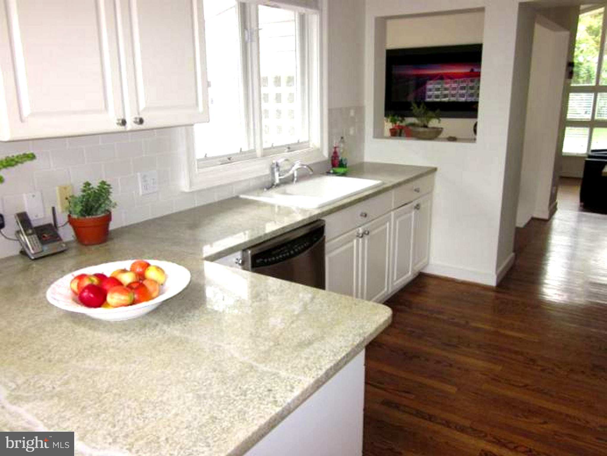 11001 Brent Road Potomac, MD 20854 - Photo 21 of 23 a kitchen with a sink a stove and cabinets