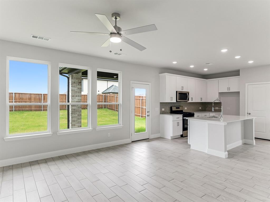 427 Magellan Road Seagoville, TX 75159 - Photo 6 of 25 a view of kitchen with stove and cabinets