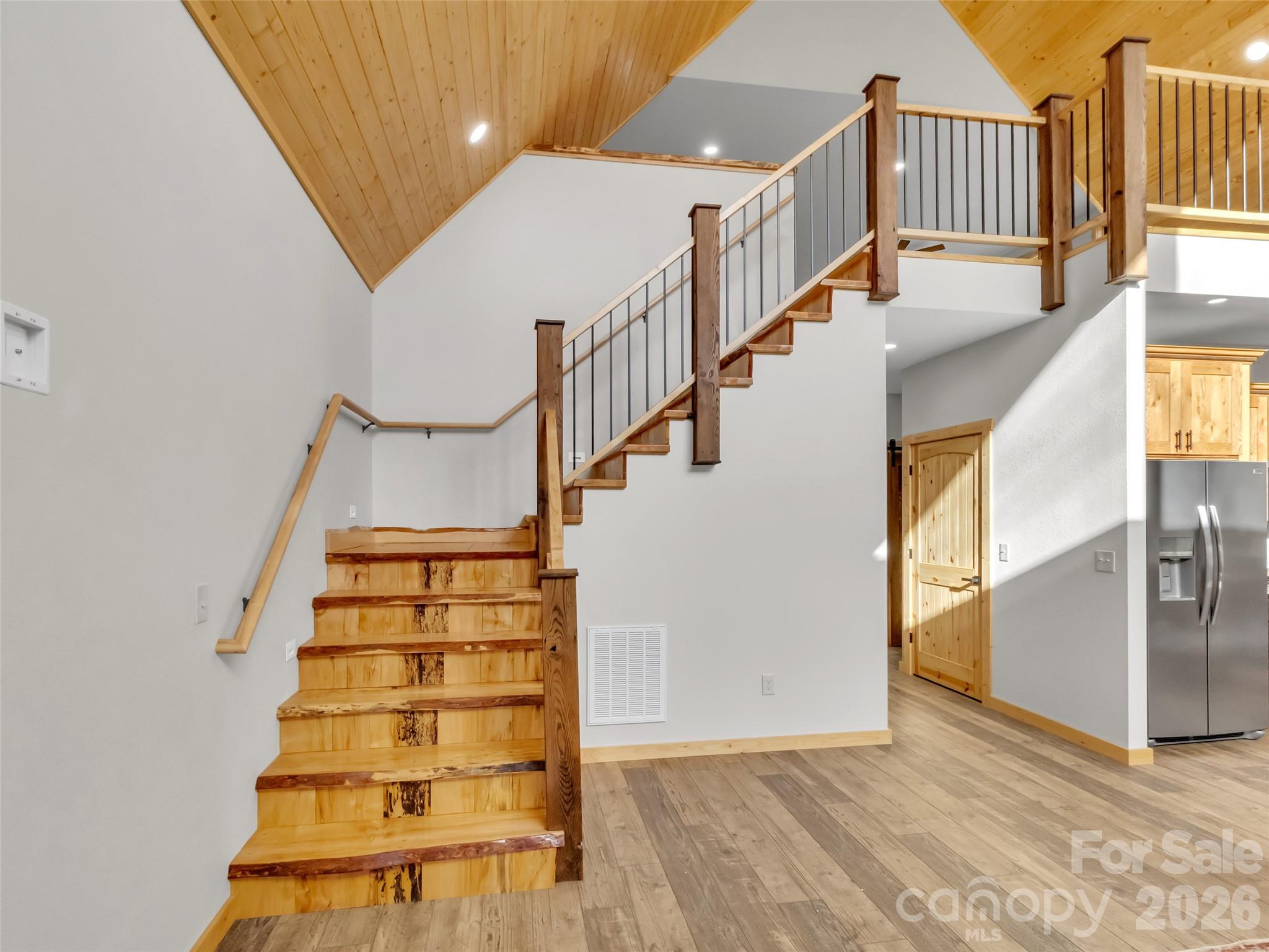 171 Cowtail Cove Clyde, NC 28721 - Photo 24 of 48 a view of entryway with wooden floor and windows
