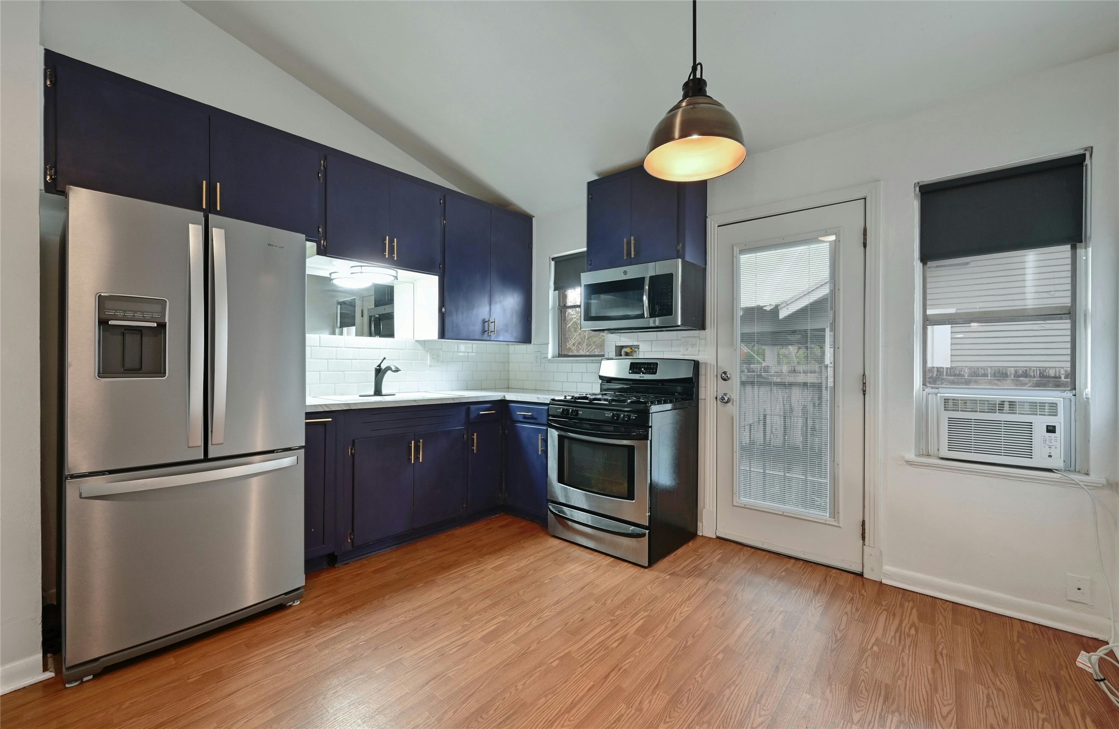 515 Pecan Grove Road, Unit A Austin, TX 78704 - Photo 8 of 17 a kitchen with stainless steel appliances a refrigerator and a stove top oven