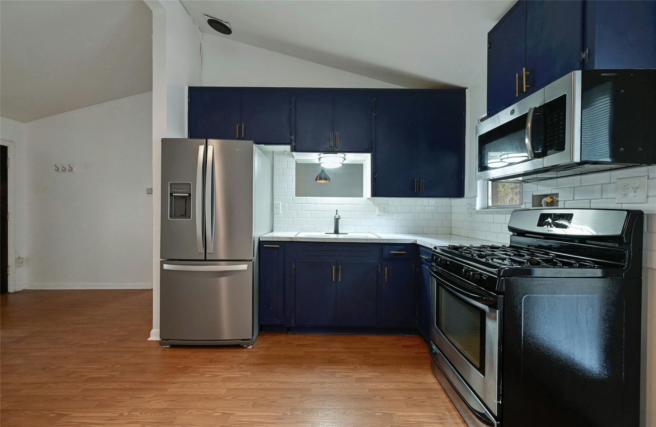 515 Pecan Grove Road, Unit A Austin, TX 78704 - Photo 9 of 17 a kitchen with stainless steel appliances wooden cabinets and a stove