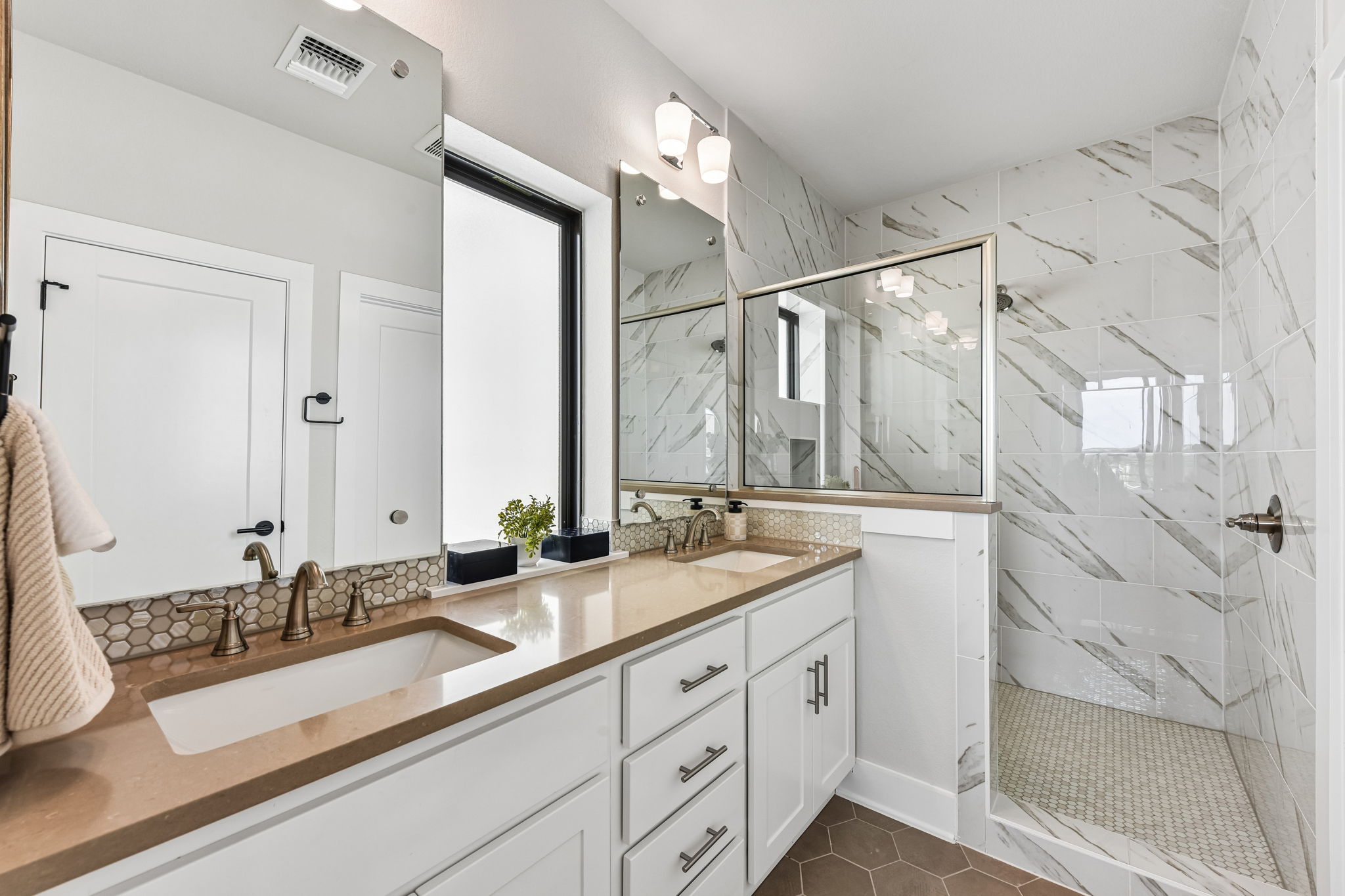9101 Cattle Baron Path Austin, TX 78747 - Photo 24 of 40 Double vanity with sleek countertops complements a spacious glass-enclosed shower.