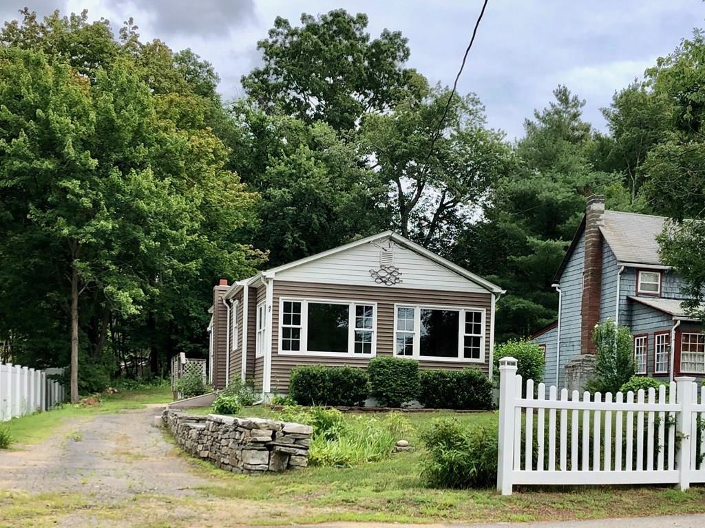 47 Union Road Wales, MA 01081 - Photo 3 of 11 a front view of a house with a yard table and chairs