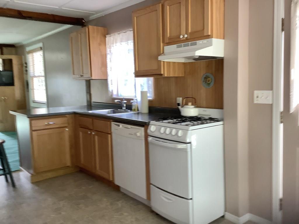 47 Union Road Wales, MA 01081 - Photo 4 of 11 a kitchen with stainless steel appliances granite countertop a sink stove and cabinets