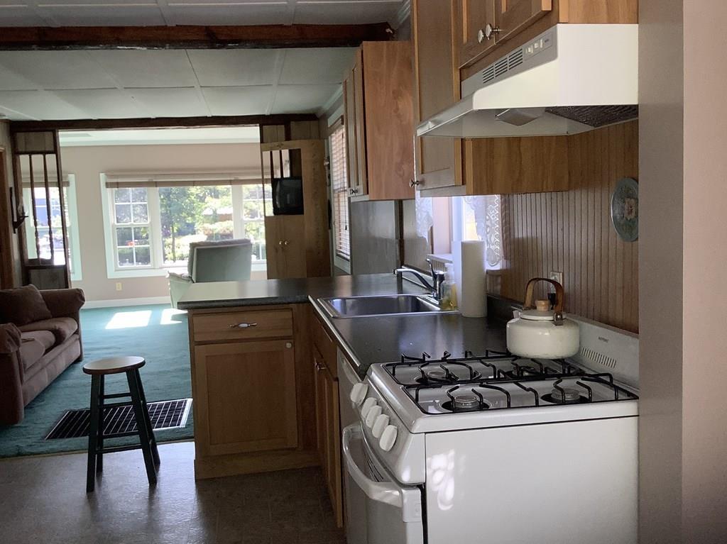 47 Union Road Wales, MA 01081 - Photo 6 of 11 a kitchen with a stove and a wooden cabinets