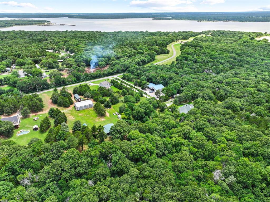 207 Paradise Park Road Pottsboro, TX 75076 - Photo 13 of 28 Expansive tree-covered landscape bordering a large body of water