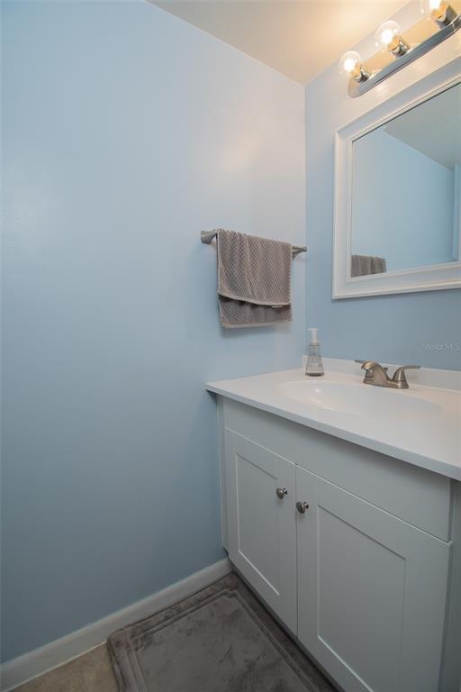 2300 Southwest 43rd Street, Unit K5 Gainesville, FL 32607 - Photo 6 of 18 a bathroom with a sink and a mirror