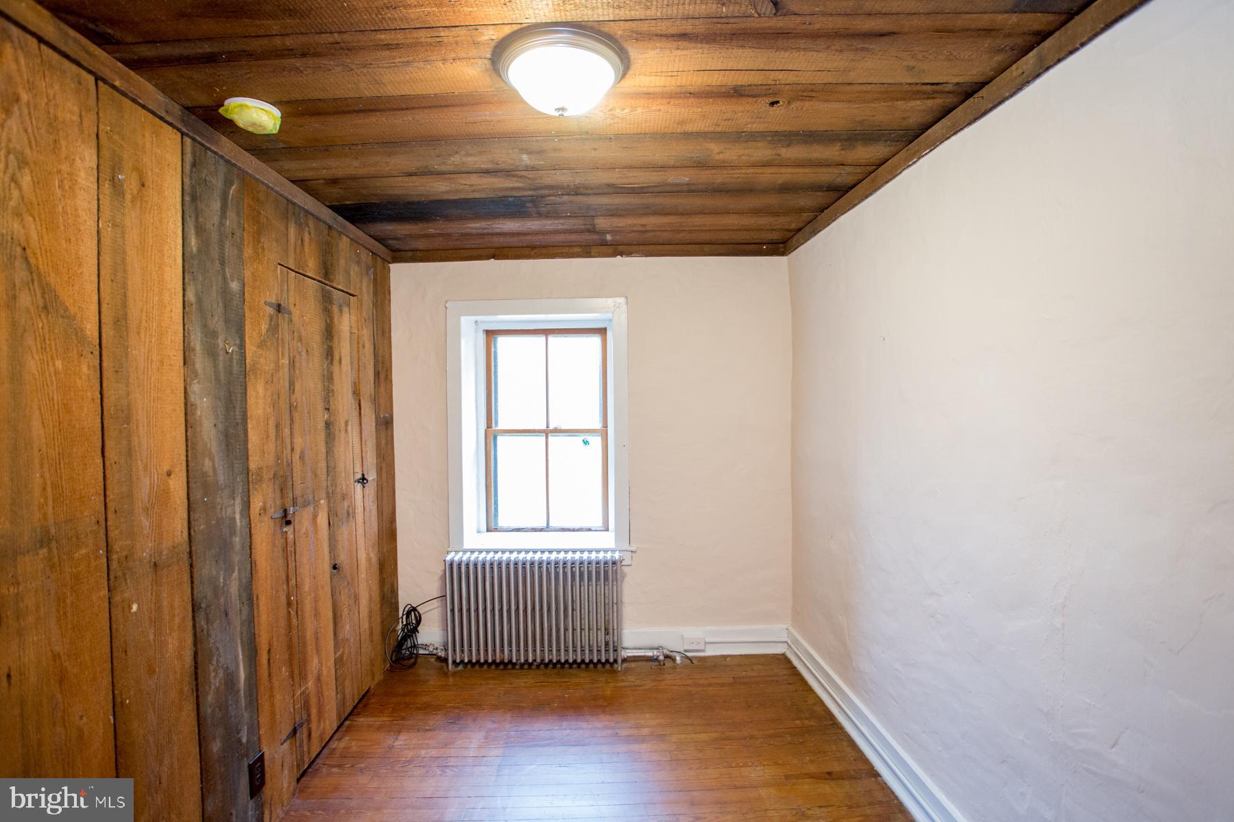 120 Tabor Road Ottsville, PA 18942 - Photo 17 of 60 an empty room with wooden floor and windows