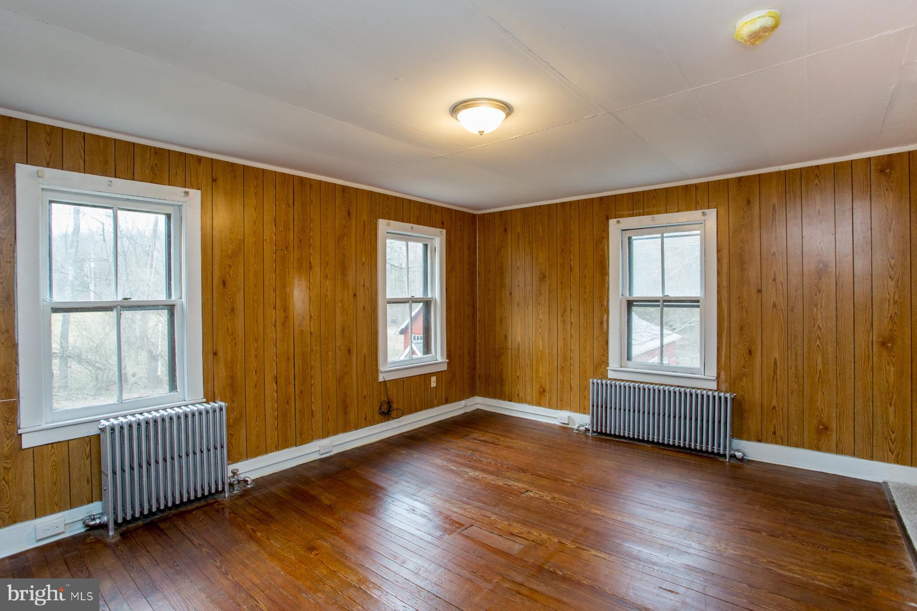 120 Tabor Road Ottsville, PA 18942 - Photo 37 of 60 an empty room with wooden floor and windows