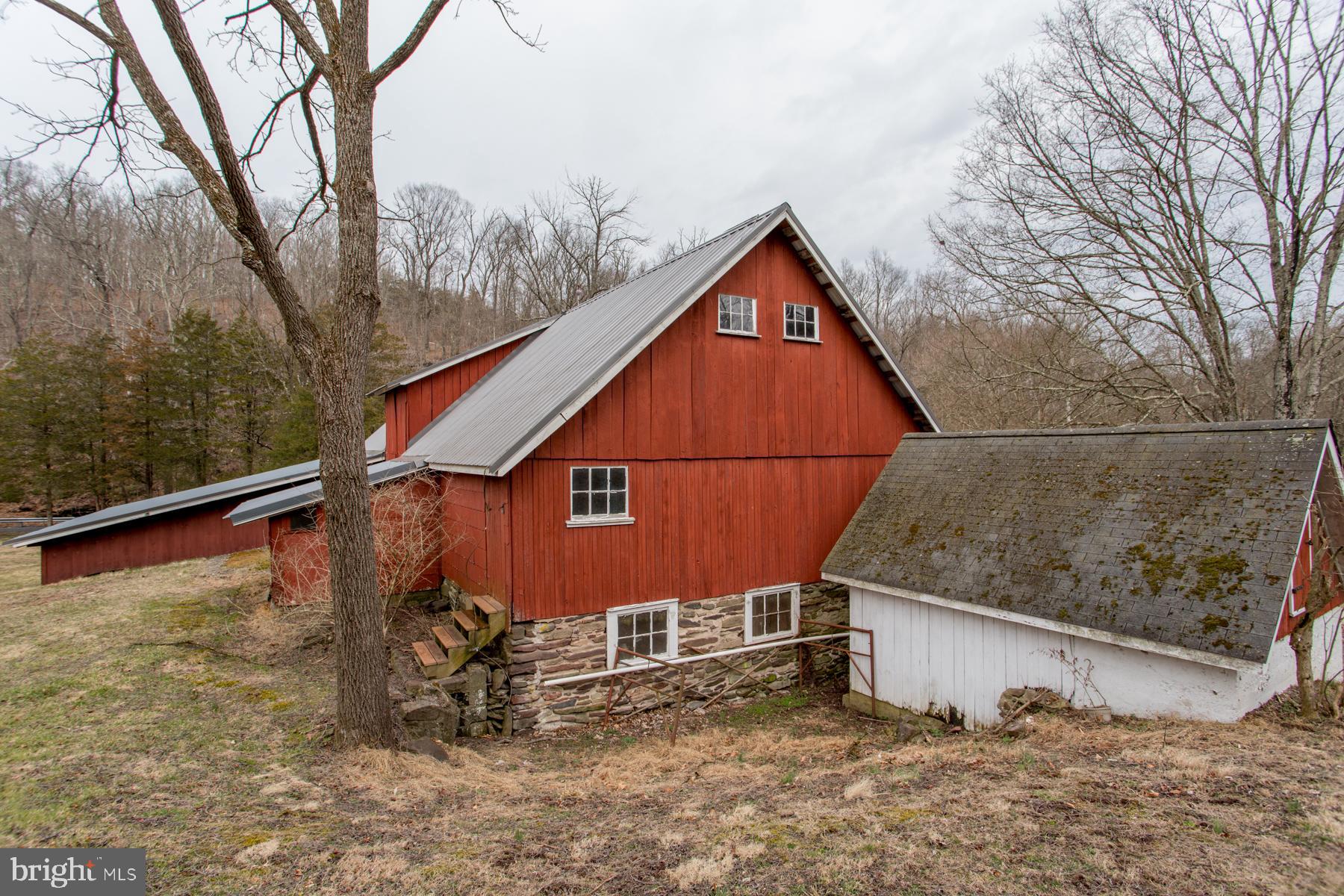 120 Tabor Road Ottsville, PA 18942 - Photo 52 of 60 a backyard of a house with large trees and outdoor seating