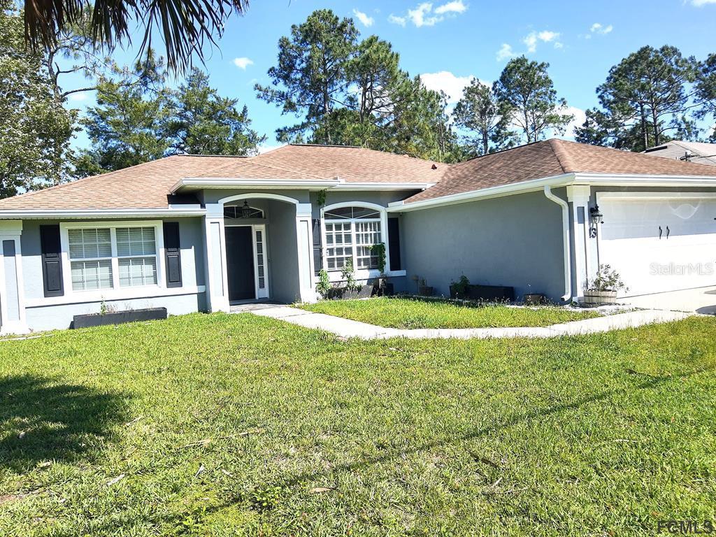 13 Ruth Drive Palm Coast, FL 32164 - Photo 1 of 1 a view of a house with a garden