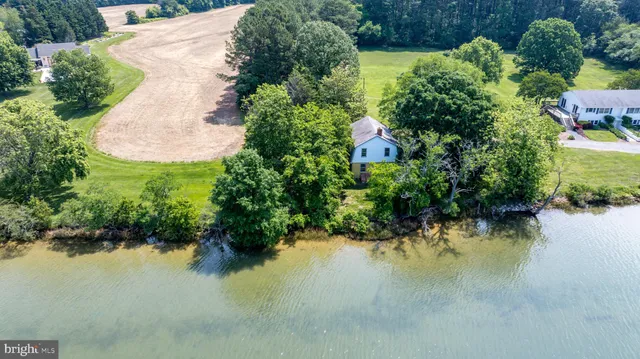 an aerial view of residential house with outdoor space and lake view