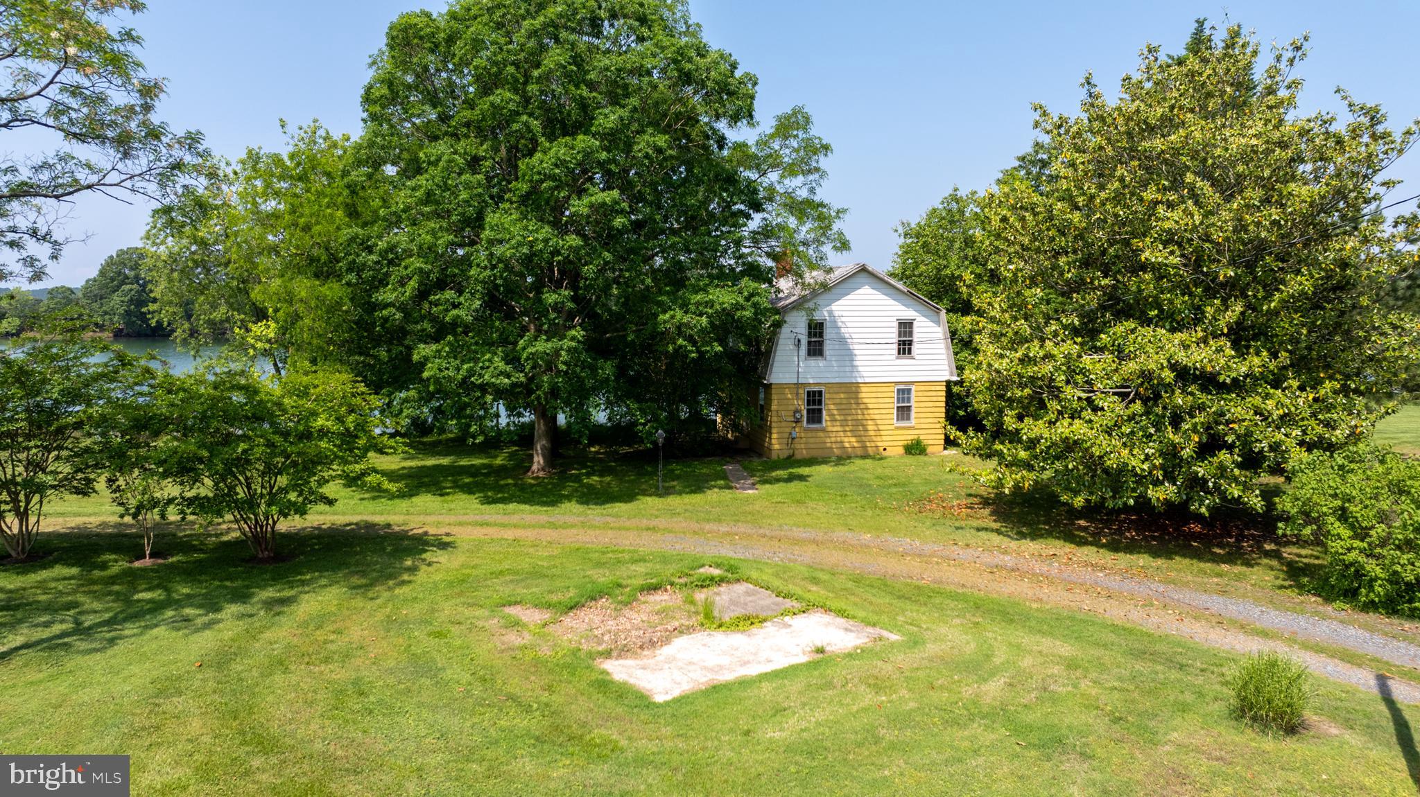 5852 Irish Creek Road Royal Oak, MD 21662 - Photo 2 of 4 a front view of a house with a yard and trees