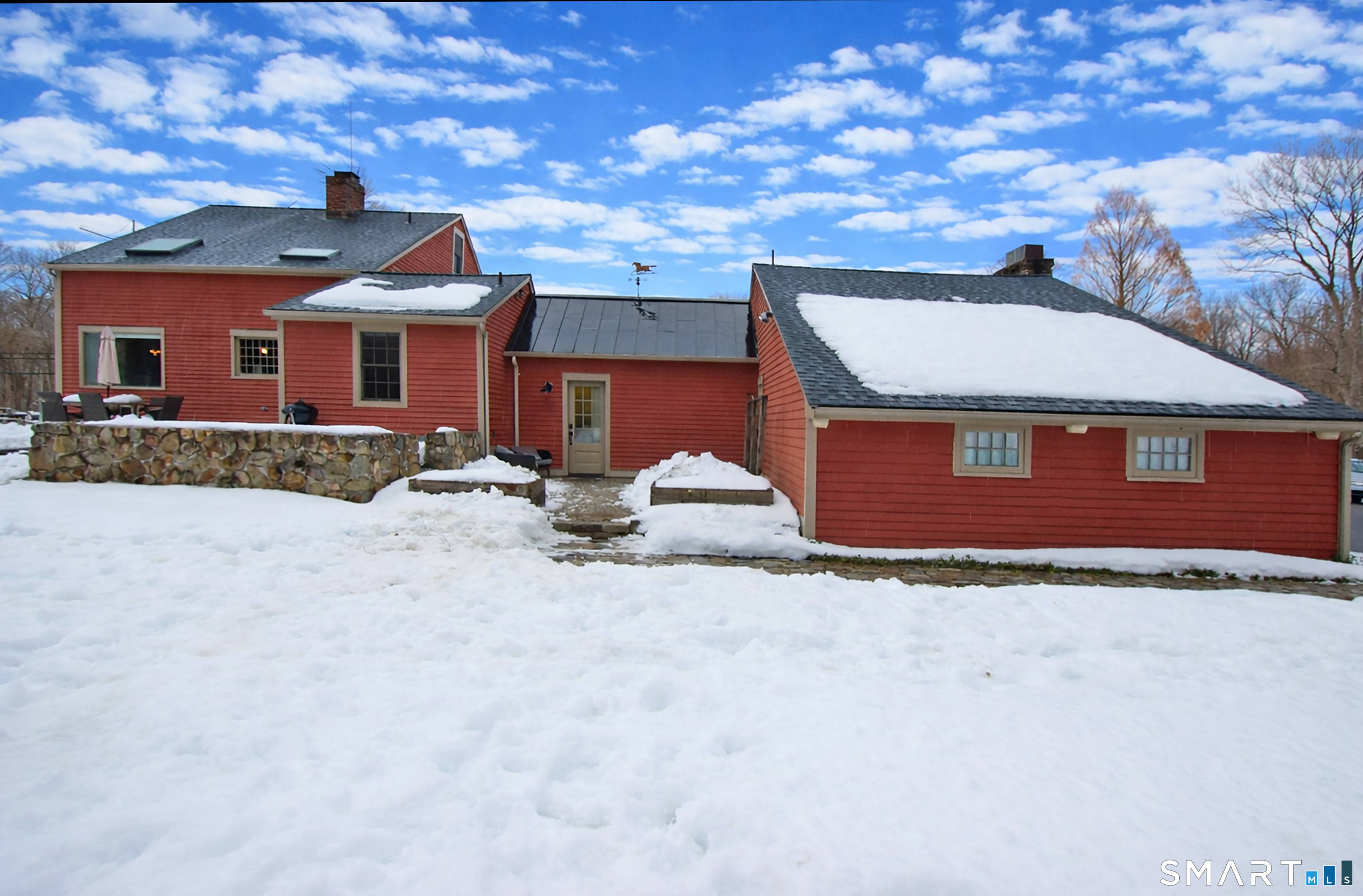 455 Barn Hill Road Monroe, CT 06468 - Photo 29 of 34 Back of house with patio leads to garage and main level mudroom with storage, laundry room