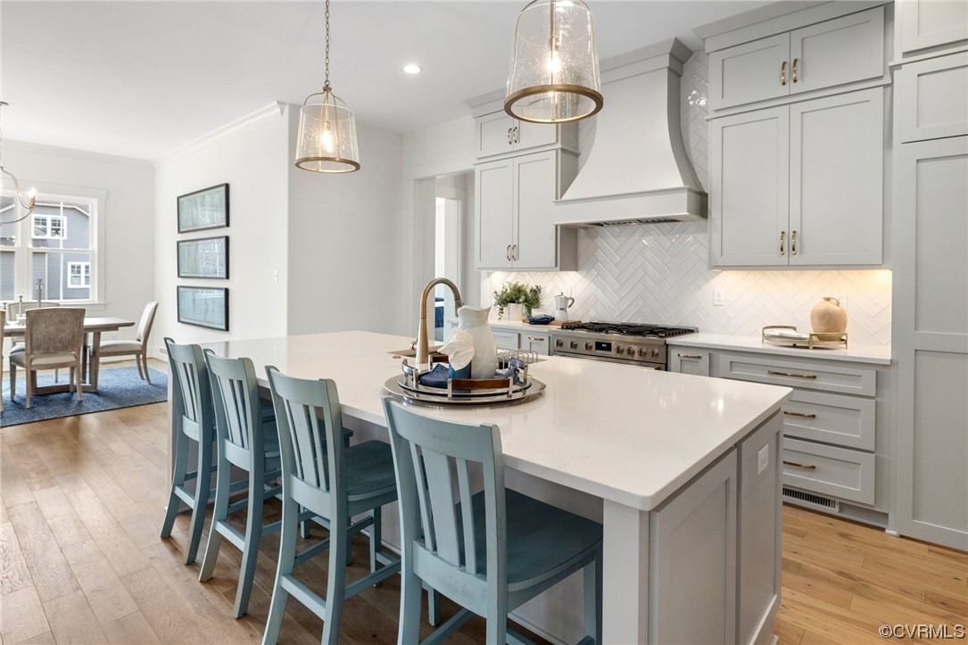5143 Lake Summer Loop Moseley, VA 23120 - Photo 16 of 49 a kitchen with a stove a table and chairs in it